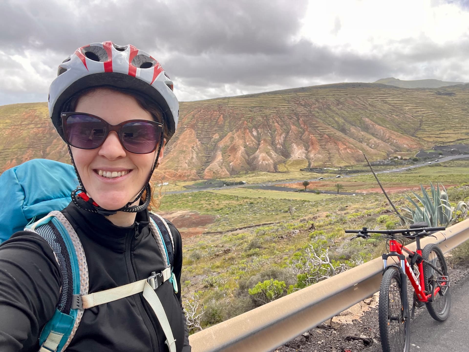 Cyclist taking a selfie with a mountain bike in the volcanic landscape of Lanzarote.