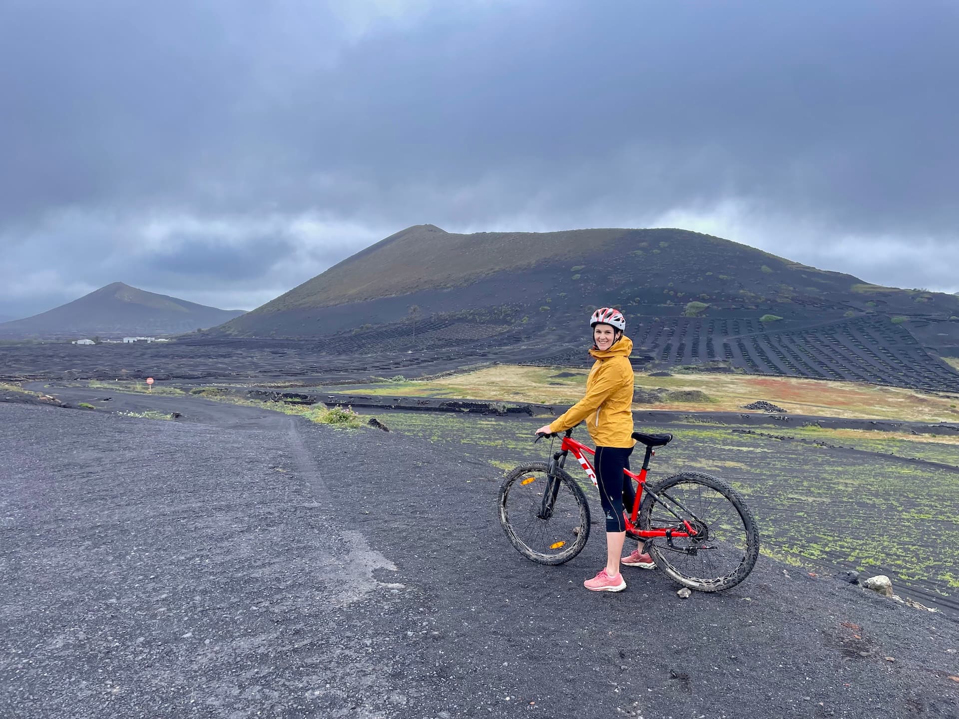 Cyclist with a mountain bike on a volcanic landscape in Lanzarote.