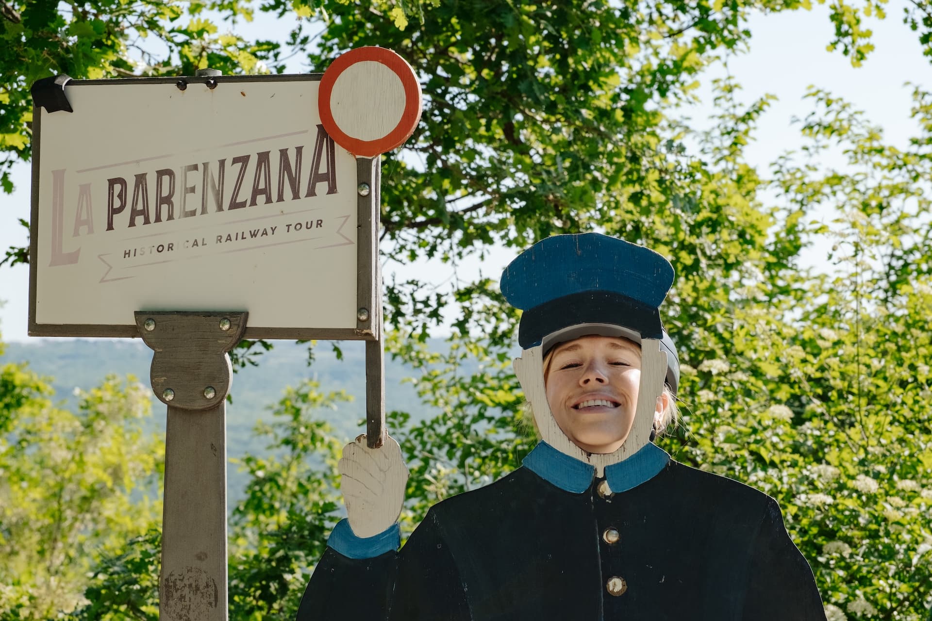 Cutout photo opportunity for La Parenzana Historical Railway Tour sign outdoors.
