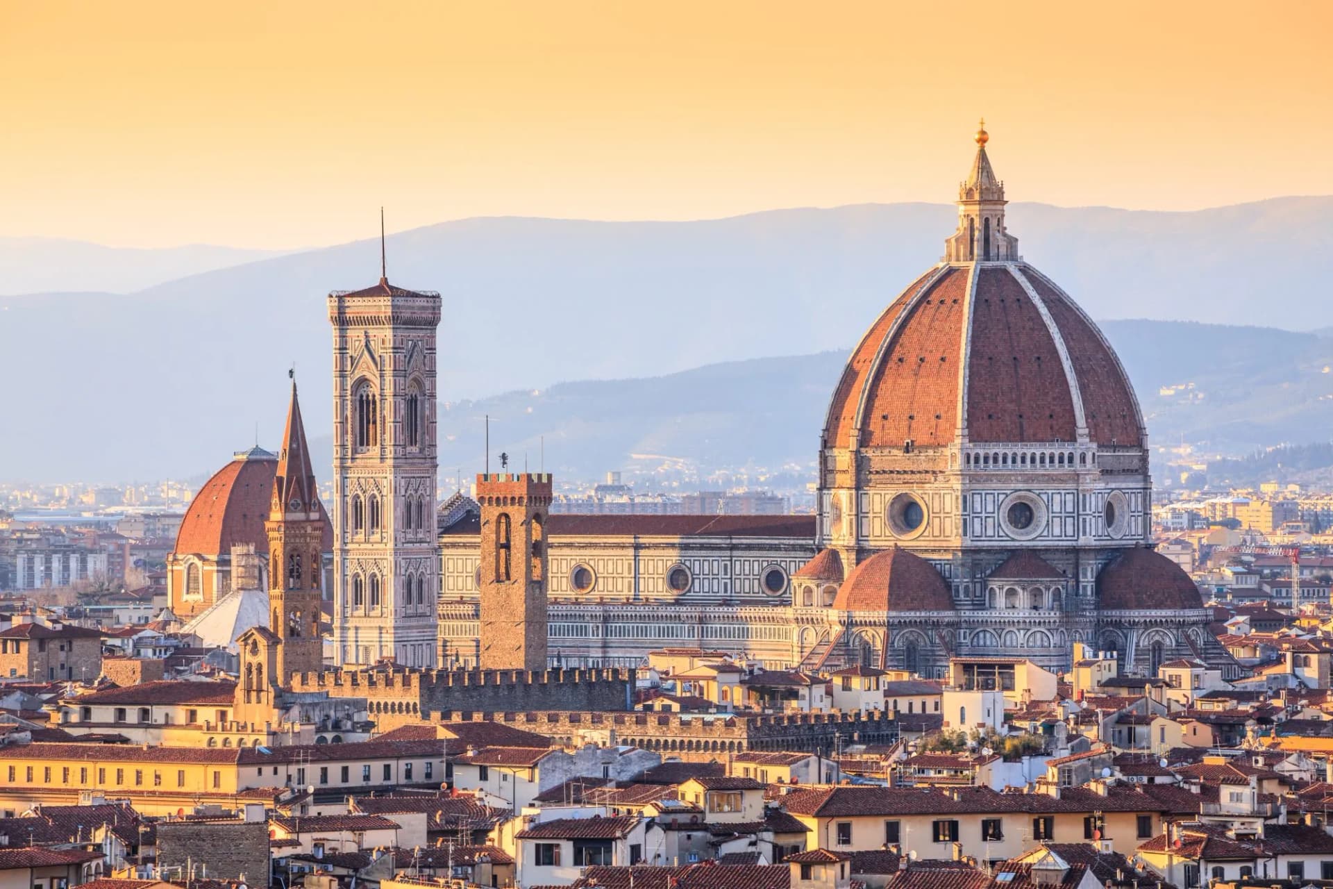 Cathedral of Santa Maria del Fiore dome and Giotto's Campanile overlooking Florence, Italy rooftops.